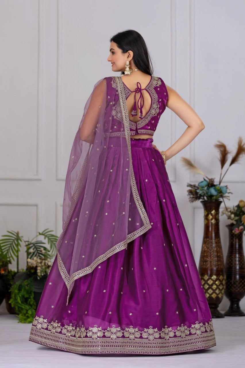 Woman in a purple traditional outfit with a white background